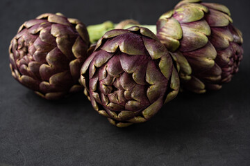 Obraz premium fresh artichokes close-up on dark gray background
