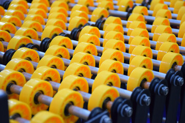 Flexible roller conveyor with variable geometry. transportation of box cargo, ribbon view close up. Yellow roller conveyor belt. delivery concept