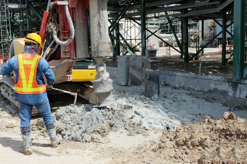 Hydraulic drilling machine is boring holes in the construction site for bored piles work. Bored...