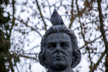 dove on the head of the monument in the park