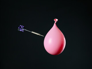 Dart and air balloon on dark background