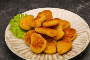 Fried chicken nuggets served salad leaves
