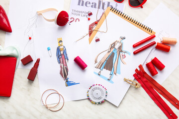 Fashion designer workplace with sketches on light background