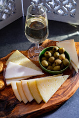 Tasting of fortified Andalusian sherry wine with traditional Spanisch tapas, green olives, goat and...