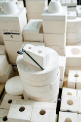 High angle view on a stack of molds for casting tableware of different size and shape. In a storage...