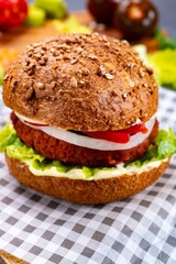 Tasty hamburger made with vegetarian plant based imitation minced meat burger and fresh vegetables