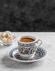 Turkish Coffee with traditional porcelain cup. Coffee presentation with Turkish delight. Sparkling Turkish Coffee.