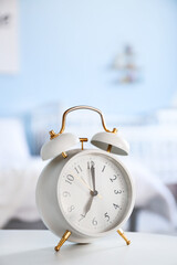 Alarm clock on table in bedroom
