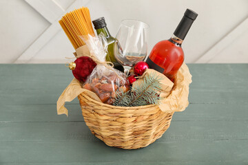 Gift basket with products and Christmas decor on table
