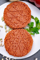 Tasty uncooked burger made with vegetarian plant based imitation minced meat ready for grill