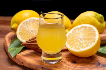 Ice cold sweet limoncello liqueur made from new harvest of fresh ripe yellow Italian lemons, Amalfi...