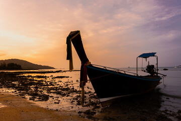 small fishing boat on the beach in the evening