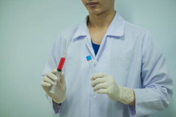 Medical technician holding a blood sample in tubes for test in the laboratory.