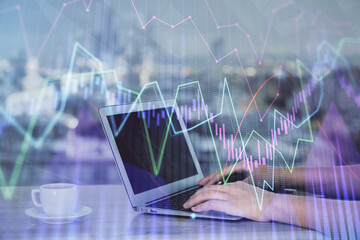 Double exposure of businesswoman hands typing on computer and forex chart hologram drawing. Financial analysis concept.