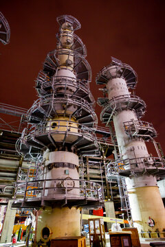 Towers inside a refinery at night time