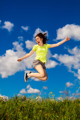 Obraz premium Girl jumping, running against cloudy sky 