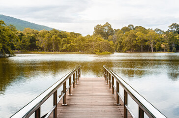 Obraz premium bridge into small mountain lake with reflect water