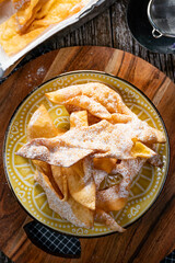 Faworki sprinkled with powdered sugar.