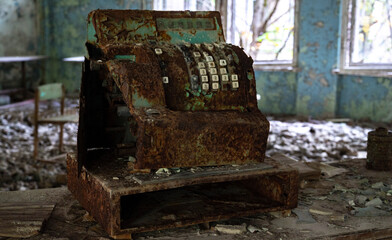 Fototapeta na wymiar old rusty cash register in abandoned shop in lost city after nuclear disaster 
