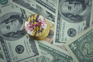 golden shining bitcoins with flag of maryland state on a dollar money background.