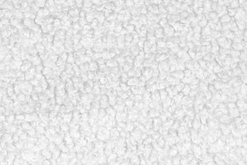 White natural texture of knitted wool textile material background. White crochet cotton fabric woven canvas texture. close up