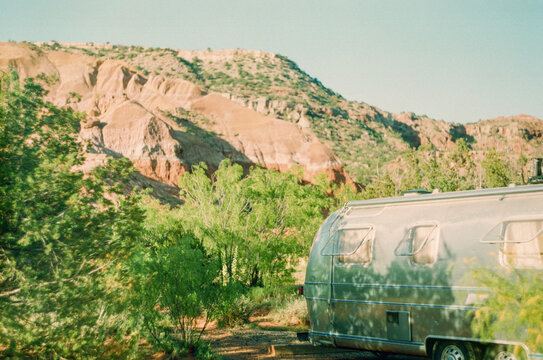 Retro Vintage RV Parked In A Dense Forest During A Holiday Trip