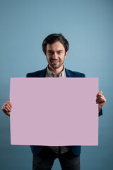 Surprised man holding pink advertising banner