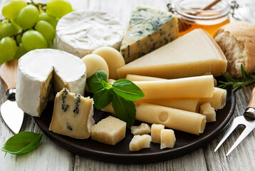 Various types of cheese  on a white wooden  background