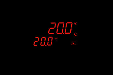 The digital thermometer on the equipment shows 20 degrees Celsius on a black background. Digital display with degrees and thermometer