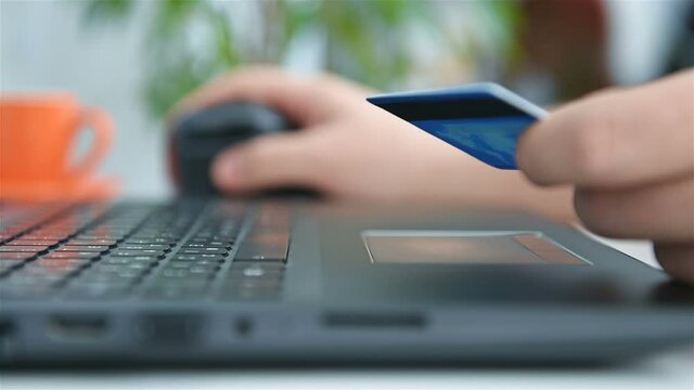 Hands Holding Credit Card And Using Laptop For  Online Shopping. Online Shopping And Lifestyle Concept. Close Up