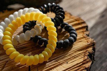 Fashionable and modern elastic hair springs. Different colors of stretching hand bracelets on wooden background, stand