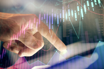 Multi exposure of man's hands holding and using a phone and financial chart drawing. Market analysis concept.