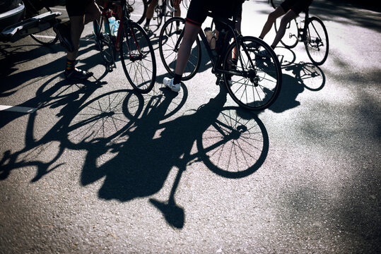 Low section of male cyclists with bicycles on street