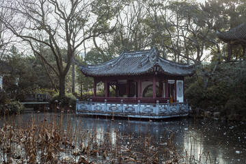 Fototapeta na wymiar Traditional Chinese pavilion by a frozen pond