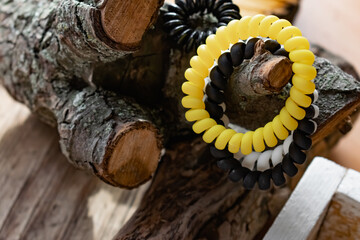 Fashionable and modern elastic hair springs. Different colors of stretching hand bracelets on wooden background, stand