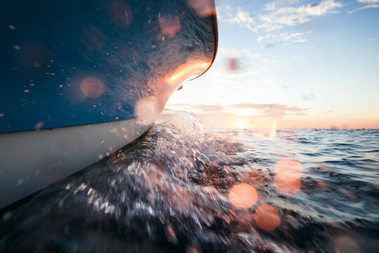 Cropped image of boat splashing water on sea