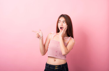 Portrait of beautiful asia young woman on Pink color background with copy space. Human face expressions, emotions feelings, body language,beauty and fashion concept.