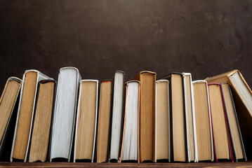 A collection of vintage books on a dark background copy space. vintage books on the shelf