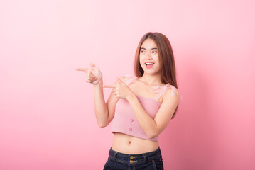 Portrait of beautiful asia young woman on Pink color background with copy space. Human face expressions, emotions feelings, body language,beauty and fashion concept.