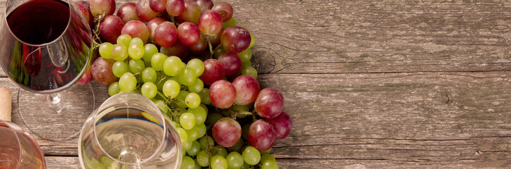 Variety of wine and snack set. Different types of grapes. Fresh ingredients on wooden background.