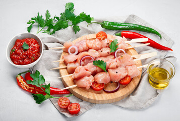 Raw and marinated chicken fillet on light background. Dietary meat.