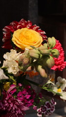 Close up. Beautiful bouquet of blooming colorful bright flowers isolated in dark background. 