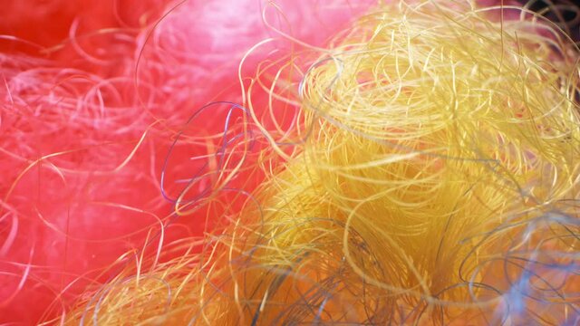 extremely close-up, detailed. multi colored curly wig hair for clown.