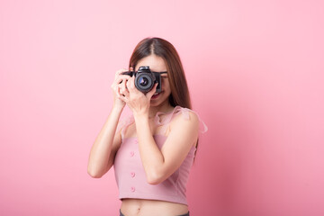 Asian woman tourist was running her to various places.happy excited emotional young woman photographer tourist standing isolated on ping background