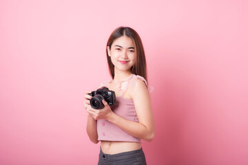 Asian woman tourist was running her to various places.happy excited emotional young woman photographer tourist standing isolated on ping background