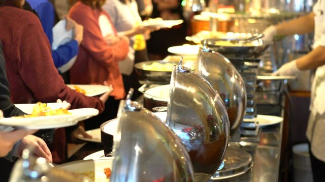 Buffet dinner catering in hotel party with prople hand grab food,  Food and drink all you can eat Concept