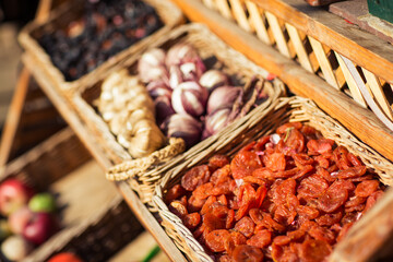 dried fruits in baskets on the showcase