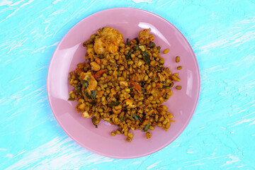 Mung beans cooking with Turkey and tomatoes. on a blue background