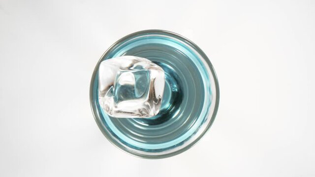 Super slow motion of falling ice cube into glass with camera motion. Filmed on high speed cinema camera, 1000 fps.
