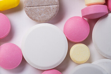 Pills of many shapes and colors grouped together